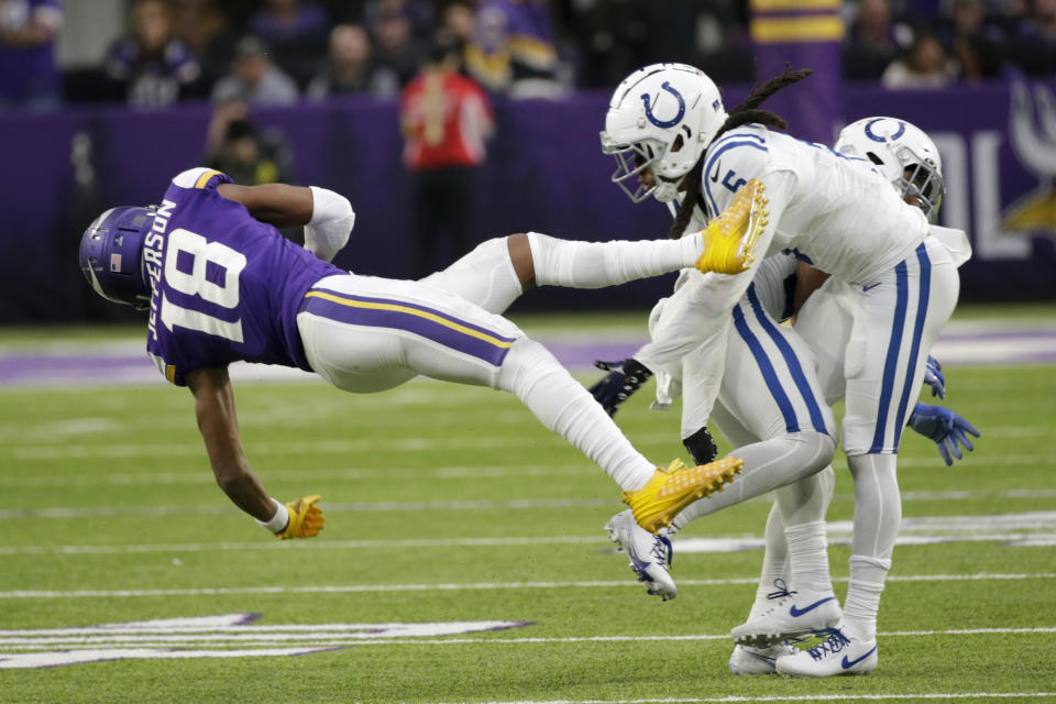 Minnesota Vikings wide receiver Justin Jefferson (18) is tackled by Indianapolis Colts cornerback Stephon Gilmore (5) during the second half of an NFL football game, Saturday, Dec. 17, 2022, in Minneapolis. (AP Photo/Andy Clayton-King)
