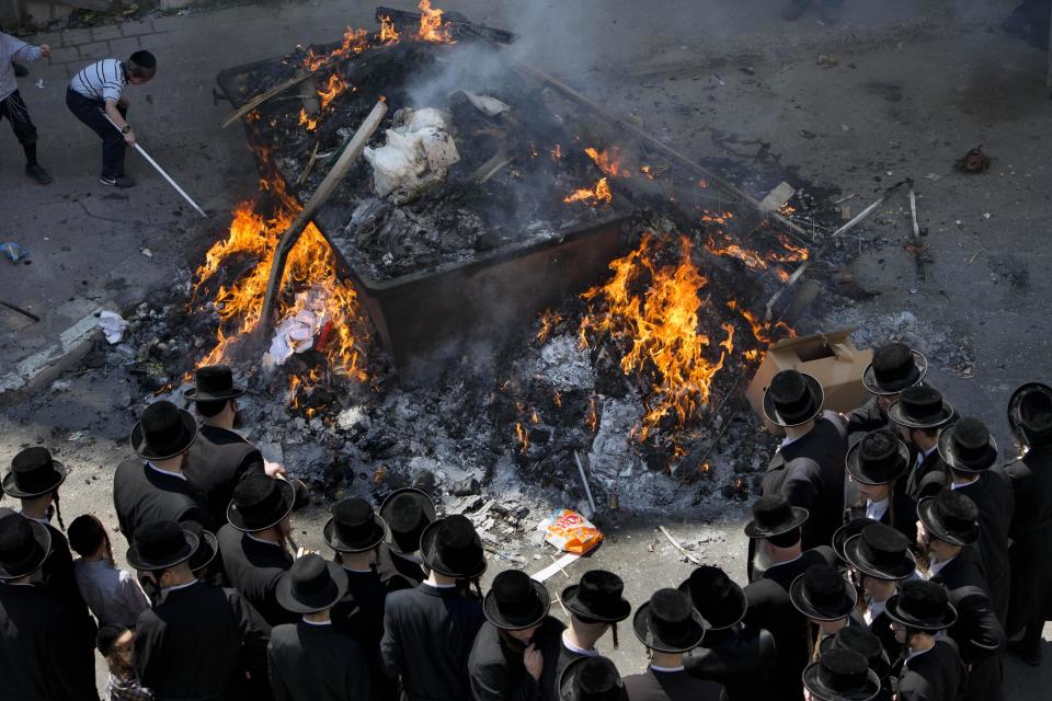 Ultra-Orthodox Jewish men burn leavened items in final preparation for the Passover holiday in the ultra-Orthodox Jewish town of Bnei Brak, near Tel Aviv, Israel, Monday, April 14, 2014. Jews are forbidden to eat leavened foodstuffs during the Passover holiday that celebrates the biblical story of the Israelites' escape from slavery and exodus from Egypt. (AP Photo/Oded Balilty)