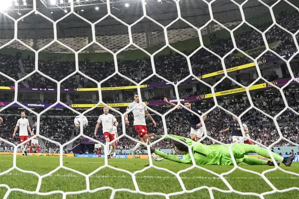 France's Olivier Giroud scores his side's opening goal during the World Cup round of 16 soccer match between France and Poland, at the Al Thumama Stadium in Doha, Qatar, Sunday, Dec. 4, 2022. (AP Photo/Natacha Pisarenko)