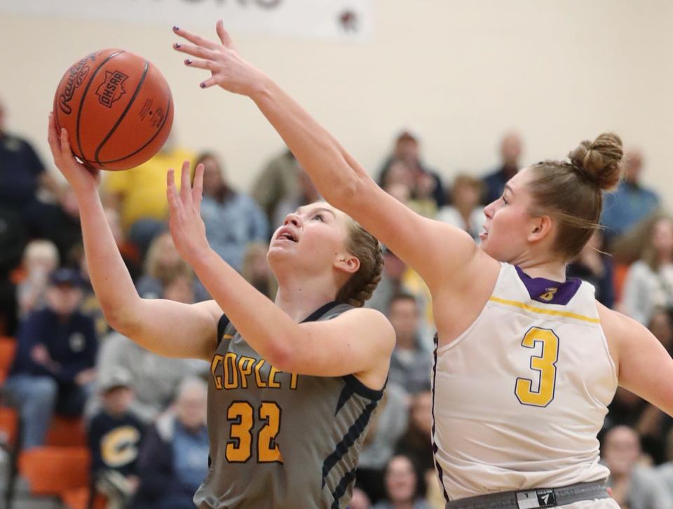 Copley's Kami Ayoup shoots as Bryan's Kailee Thiel defends in a Division II regional final March 8 in Mansfield.