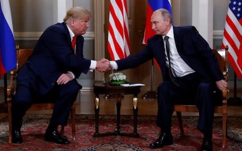 Vladimir Putin and Donald Trump shake hands - Credit: Kevin Lamarque/Reuters