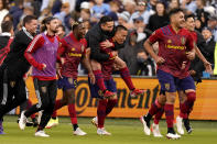 Real Salt Lake players celebrate after their MLS soccer match against Sporting Kansas City Sunday, Nov. 28, 2021, in Kansas City, Kan. Real Salt Lake won 2-1.(AP Photo/Charlie Riedel)