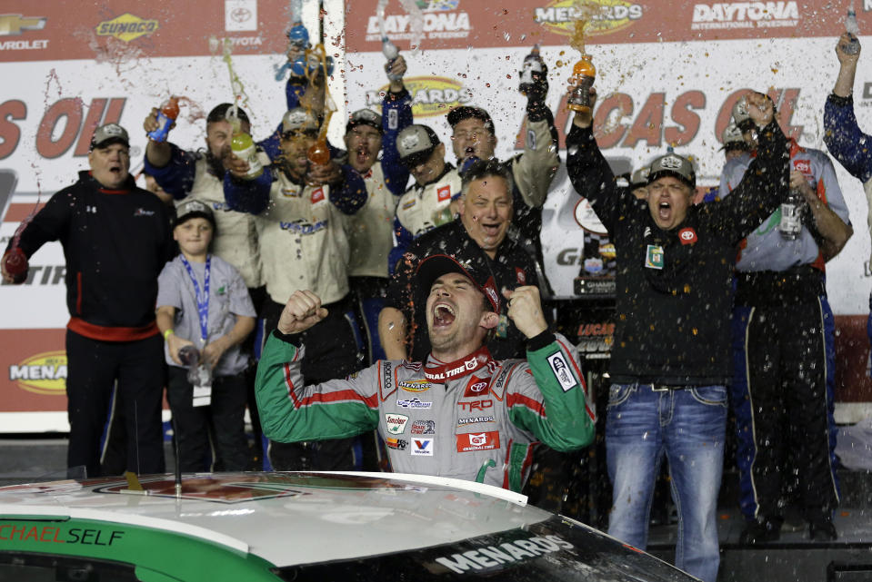 Michael Self, center, celebrates with crew members in Victory Lane after winning the ARCA auto race at Daytona International Speedway, Saturday, Feb. 8, 2020, in Daytona Beach, Fla. (AP Photo/Terry Renna)