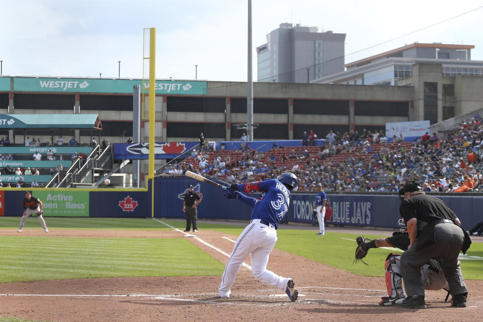 Toronto Blue Jays' Teoscar Hernandez (37) hits a two-RBI single during the sixth inning of a baseball game against the Baltimore Orioles in Buffalo, N.Y., Saturday, June 26, 2021. (AP Photo/Joshua Bessex)