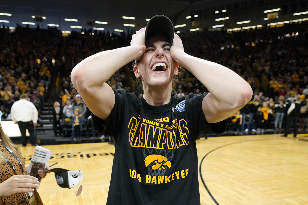 Iowa guard Caitlin Clark celebrates on the court after an NCAA college basketball game against Michigan, Sunday, Feb. 27, 2022, in Iowa City, Iowa. Iowa won 104-80. The victory gave Iowa a share of the Big Ten Conference championship. (AP Photo/Charlie Neibergall)