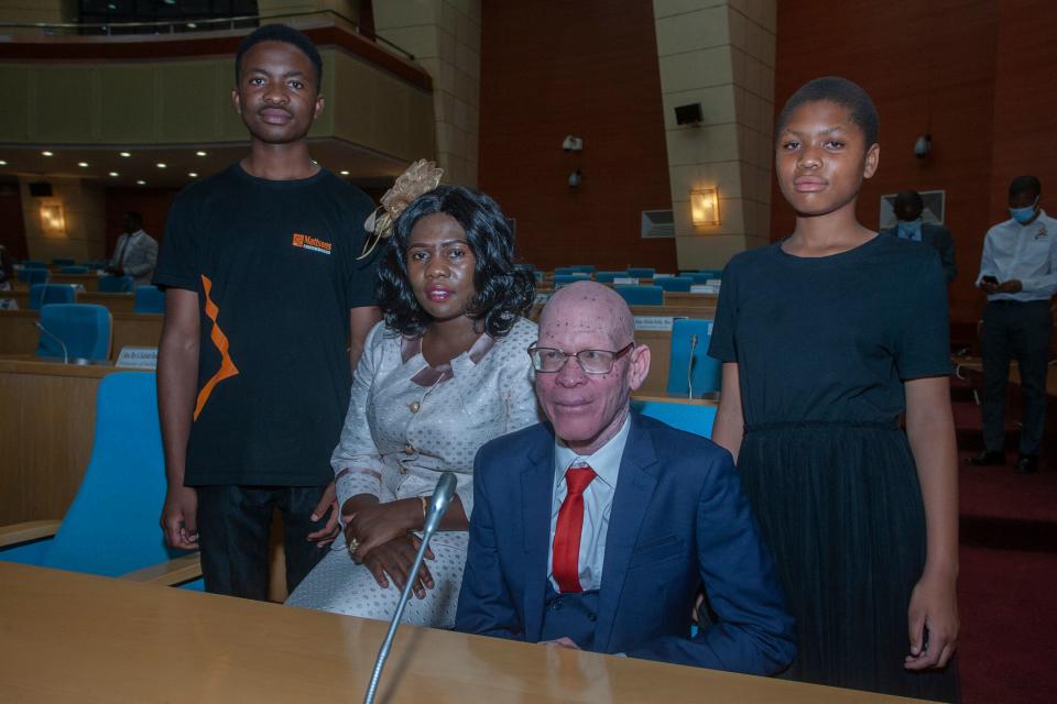 Former President for the Association of People with Albinism in Malawi, Overstone Kondowe (2nd L),  poses with his wife Memory (2nd R), and their children, Promise (L), and Ellen (R), in Malawi's parliament on November 4, 2021. - An albino activist was sworn in to Malawi's parliament on November 4, 2021, in a first for the country.
Overstone Kondowe won a by-election last month in central Malawi, a milestone in a county where people with albinism have suffered discrimination and killings. (Photo by AMOS GUMULIRA / AFP) (Photo by AMOS GUMULIRA/AFP via Getty Images)