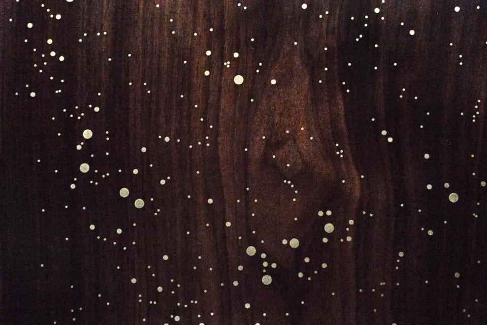 This undated photo provided by Asher Israelow Studio shows a Star Map table with brass inlay in a single walnut slab, which is part of a series of tables for stargazers. Brooklyn furniture designer, Asher Israelow, (www.asherisraelow.com) will create a custom Star Map table by researching what the night sky looked like for your specific date, and reproducing it with brass inlay on walnut. (AP Photo/Asher Israelow Studio)