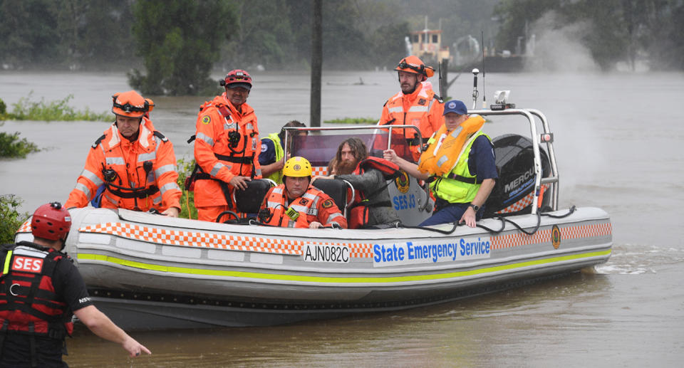 A family of four, including two young children, had their rescue boat capsize during their evacuation from a flooded property at Upper Colo. Source: AAP