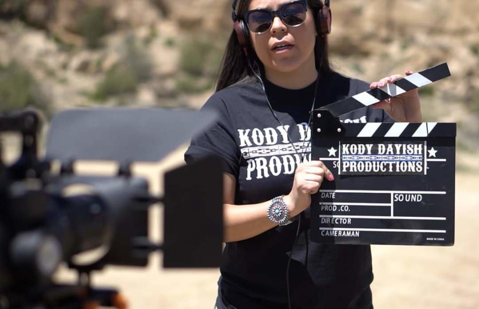 Kolette Dayish holds a slate during the filming of a project for Kody Dayish Productions.