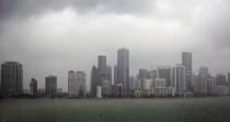 Rain falls upon the Miami skyline Monday, Sept. 3, 2018. Tropical Storm Gordon lashed South Florida with heavy rains and high winds on Monday, forcing holiday beachgoers to drier ground. Weather forecasters said the storm could strengthen to near-hurricane force by the time it hits the central U.S. Gulf Coast. (C.M. Guerrero/Miami Herald via AP)