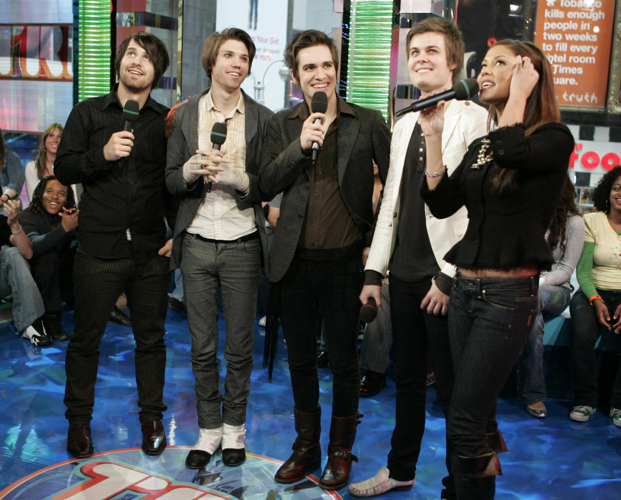 FILE - Members of "Panic! at the Disco," from left, Brent Wilson, Ryan Ross, Brendon Urie and Spencer Smith appear with host Vanessa Minnillo during MTV's "Total Request Live" show in New York on Nov. 14, 2006. Urie, the only musician left from the original group, announced on the band’s Instagram page Tuesday that Panic! at the Disco “will be no more.” Urie shared that he and his wife, Sarah, are expecting a baby and that he plans to focus on his family. (AP Photo/Jeff Christensen, File)