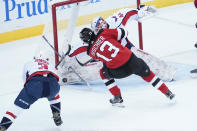 New Jersey Devils center Nico Hischier (13) skates against Washington Capitals goaltender Vitek Vanecek (41) during the first period of an NHL hockey game, Saturday, Feb. 27, 2021, in Newark, N.J. (AP Photo/Mary Altaffer)