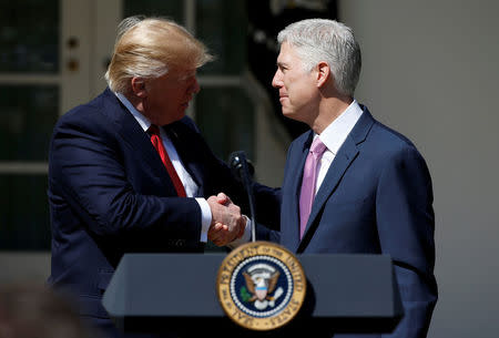 FILE PHOTO: U.S. President Donald Trump shakes hands with Judge Neil Gorsuch after he was sworn in as an Associate Supreme Court in the Rose Garden of the White House in Washington, U.S. on April 10, 2017. REUTERS/Joshua Roberts/File Photo