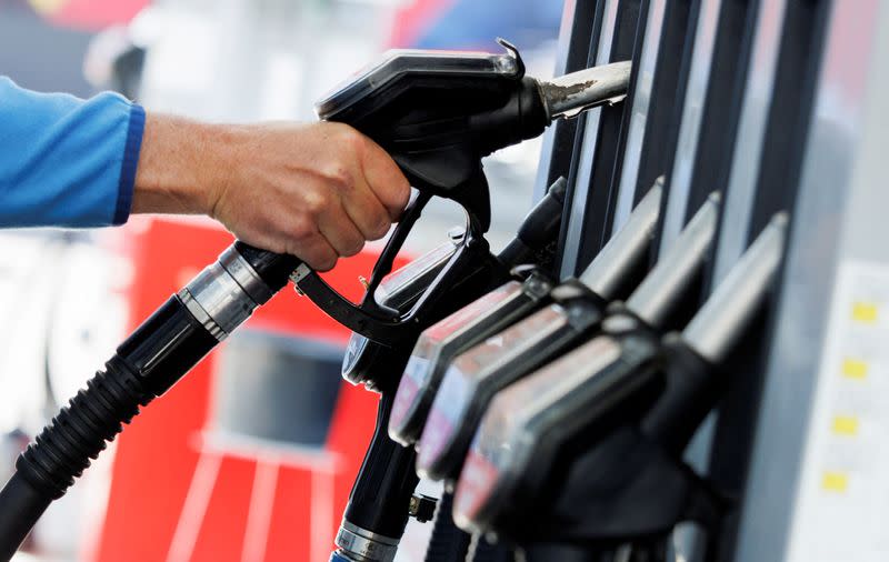 FILE PHOTO: A motorist refuels his vehicle at a gas station in Munich