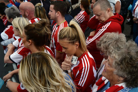 Football fans and wellwishers gather on the day of the funeral of Bradley Lowery, in Blackhall Colliery, Britain July 14, 2017. REUTERS/Mary Turner