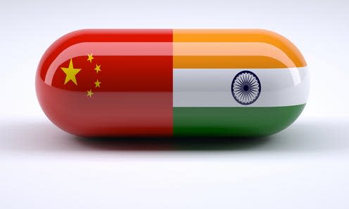   <span class="attribution"><a class="link " href="https://www.shutterstock.com/image-illustration/pill-chinese-indian-flag-wrapped-around-547488079" rel="nofollow noopener" target="_blank" data-ylk="slk:Shutterstock/FabioBerti;elm:context_link;itc:0;sec:content-canvas">Shutterstock/FabioBerti</a></span>