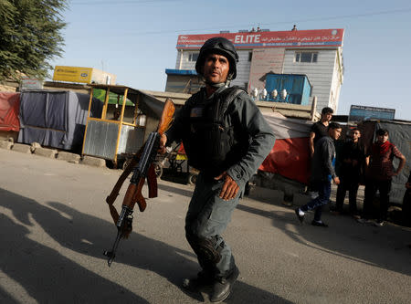 FILE PHOTO: Afghan policemen arrive at the site of a suicide bomb blast in Kabul, Afghanistan August 15, 2018. REUTERS/Omar Sobhani