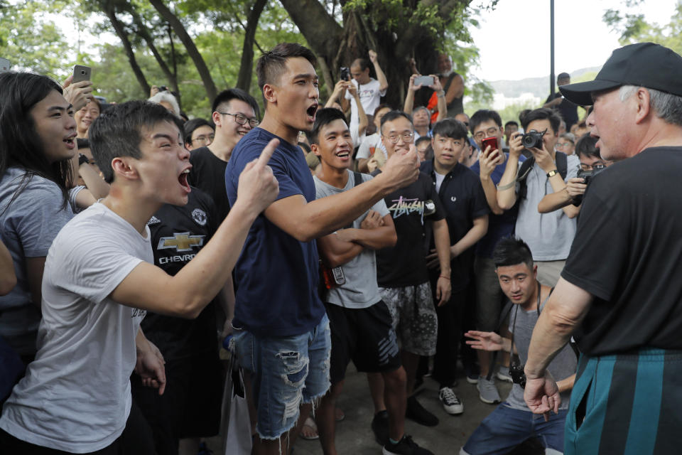 People argue at the Tuen Mun Park, in Hong Kong, Saturday, July 6, 2019 as hundreds of protesters gathered, protesting against mainland Chinese singers causing nuisance to the local neighborhood. The extradition protest sparked Hong Kong netizen to line more protest during the weekend, with focus on some local conflicts between mainland Chinese and Hong Kongers. (AP Photo/Kin Cheung)