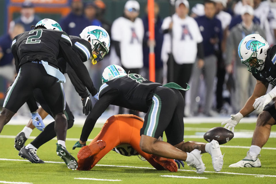 UTSA running back Kevorian Barnes fumbles in the second half of an NCAA college football game against Tulane in New Orleans, Friday, Nov. 24, 2023. Tulane won 29-16. (AP Photo/Gerald Herbert)
