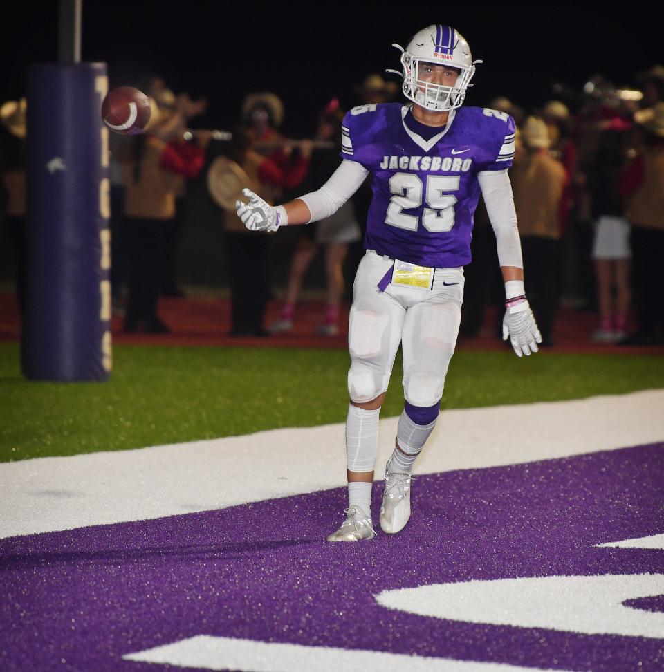Jacksboro runningback Baylor Laake tosses the ball to an official after scoring a touchdown Friday night against Eastland.