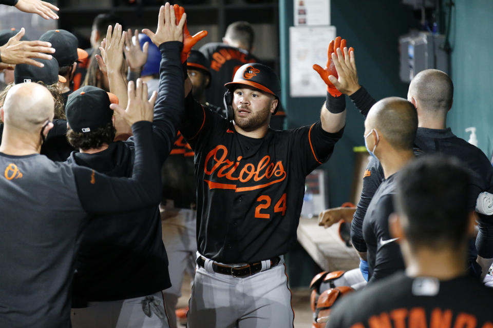 Baltimore Orioles' DJ Stewart (24) is congratulated by teammates after a home run in the fifth inning of the team's baseball game against the Texas Rangers in Arlington, Texas, Friday, April 16, 2021. (AP Photo/Roger Steinman)