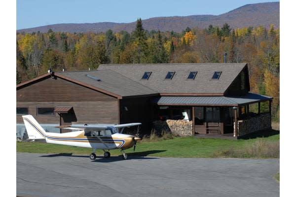 Photo tour of a nuclear bunker house exterior with plane