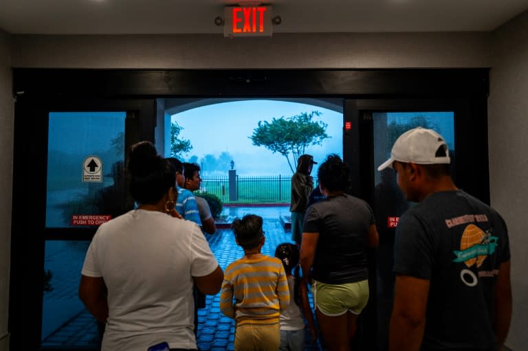 Families watch Hurricane Francine from the entrance of their hotel on September 11, 2024 in Houma, Louisiana (Brandon Bell)