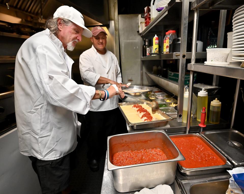 Piccolo's Restaurant assistant manager John Piccolo, left, and chef Marcio Santos prepare lasagna.