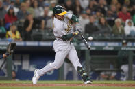 Oakland Athletics' Ramon Laureano hits a single to score Matt Chapman during the eighth inning of athe team's baseball game against the Seattle Mariners, Thursday, July 22, 2021, in Seattle. (AP Photo/Ted S. Warren)