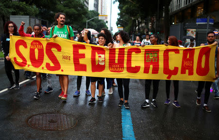 People protest against cuts to federal spending on higher education planned by Brazil's President Jair Bolsonaro's right-wing government, in Rio de Janeiro, Brazil May 15, 2019. The banner reads: "S.O.S. education." REUTERS/Pilar Olivares
