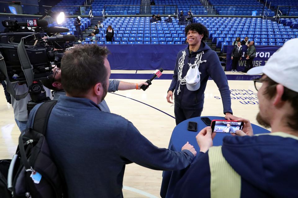 Akron Zips forward Enrique Freeman shares a laugh with local media during the team's watch party for the NCAA Tournament Selection Show at Rhodes Arena on Sunday.