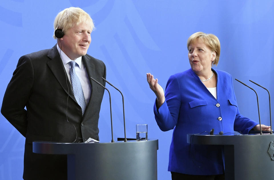 Germany's Chancellor Angela Merkel and British Prime Minister Boris Johnson attend a joint press conference, in Berlin, Wednesday, Aug. 21, 2019. German Chancellor Angela Merkel says she plans to discuss with UK Prime Minister Boris Johnson how Britain's exit from the European Union can be "as frictionless as possible." (Jorg Carstensen/dpa via AP)