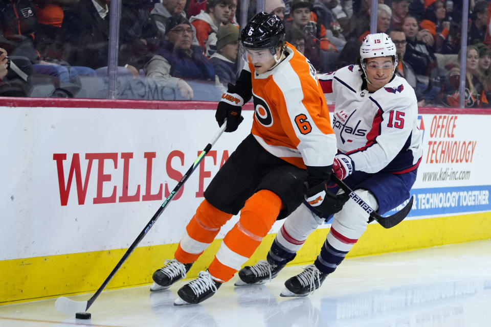 Philadelphia Flyers' Travis Sanheim, left, tries to keep away from Washington Capitals' Sonny Milano during the third period of an NHL hockey game, Wednesday, Jan. 11, 2023, in Philadelphia. (AP Photo/Matt Slocum)