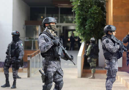 Police officers stand guard outside the building where accused drug kingpin Damaso Lopez, nicknamed “The Graduate", was arrested in Mexico City, Mexico May 2, 2017. REUTERS/Henry Romero