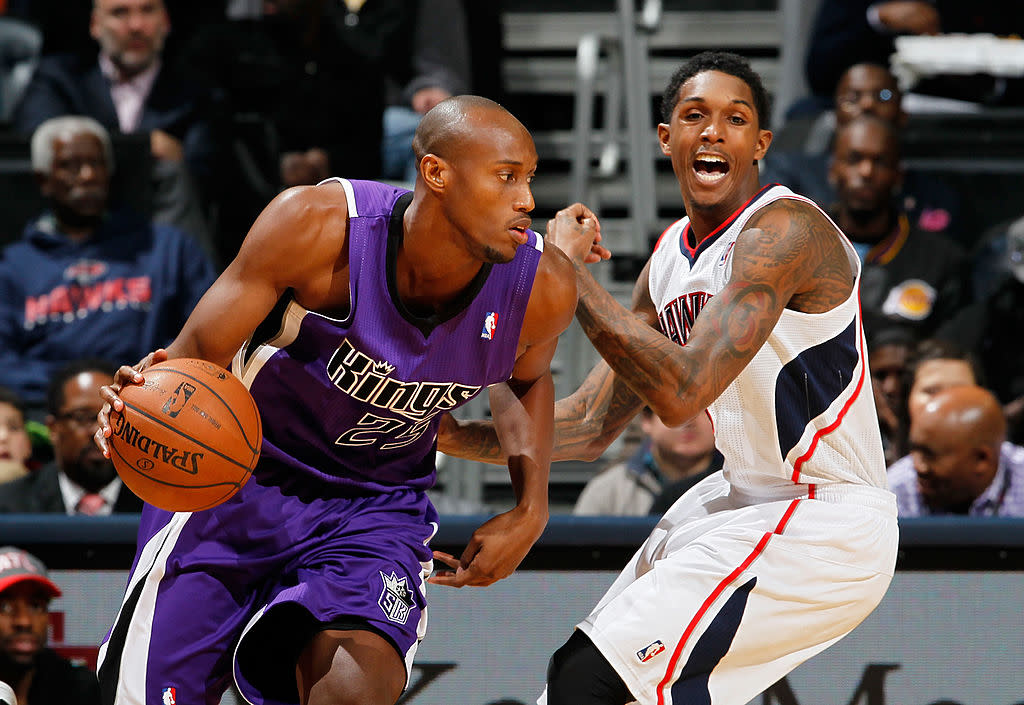 Travis Outlaw of the Sacramento Kings dribbles against Louis Williams of the Atlanta Hawks on December 18, 2013. (Kevin C. Cox/Getty Images)