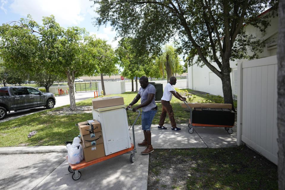 Cousin Johnny McGriff, left, and uncle Billy McGriff Sr. help move Freddie Davis' furniture and possessions into a storage unit, as Davis prepares for an eviction that he knows could come at any time, Monday, Sept. 6, 2021, in Miami. According to the latest data from the Eviction Lab at Princeton University, evictions have been rising in most of the 31 cities and six states where it collects data. (AP Photo/Rebecca Blackwell)