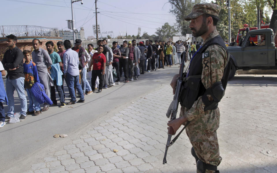 FILE - In this March 5, 2017 file photo a Pakistan army soldier stands guard during the Pakistan Super League match at Gaddafi stadium in Lahore, Pakistan. The Pakistan Super League is not like any other domestic Twenty20 cricket league around the world. It can't compete financially with the lucrative Indian Premier League in terms of player payments, yet it's a dream for Pakistani cricketer to be part of it. For the Pakistan Cricket Board, the PSL is a pathway to ultimately bring foreign teams back to Pakistan and resume fully-fledged international cricket on home soil. (AP Photo/K.M. Chaudary, File)