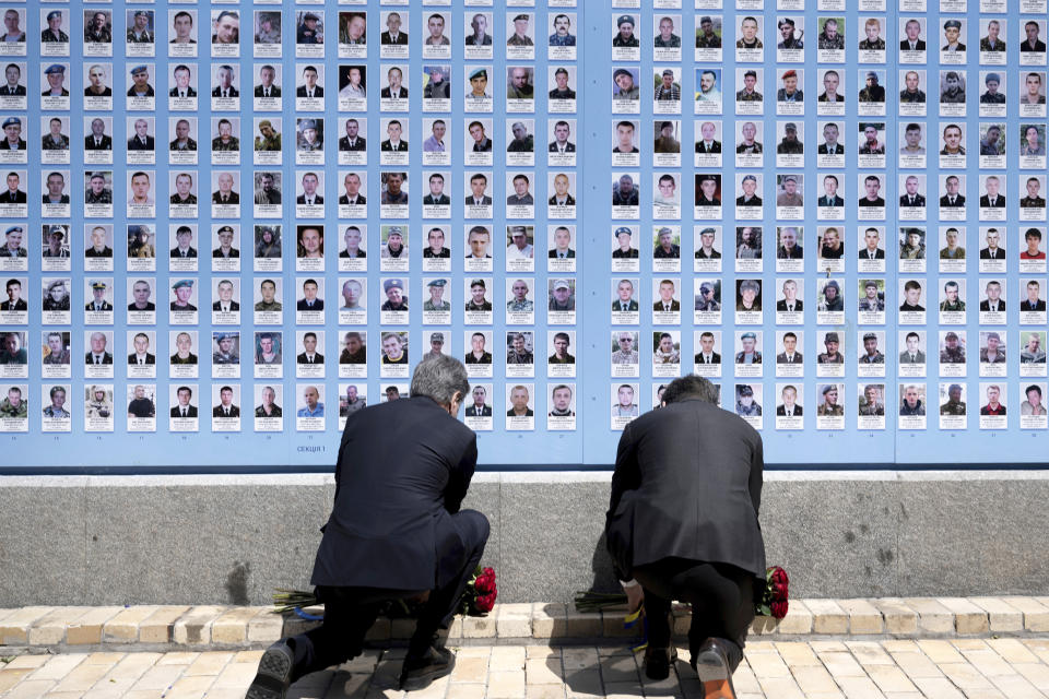 US Secretary of State Antony Blinken, left, and Ukrainian Foreign Minister Dmytro Kuleba lay flowers at the Memory Wall of Fallen Defenders of Ukraine outside the Saint Michael's Golden Domed Monastery, in Kyiv on Wednesday, May 15, 2024. (Brendan Smialowski/Pool Photo via AP)