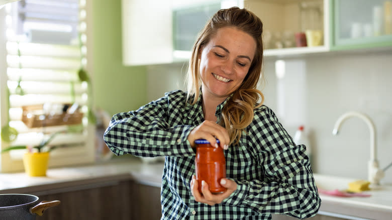 Woman opening a jar