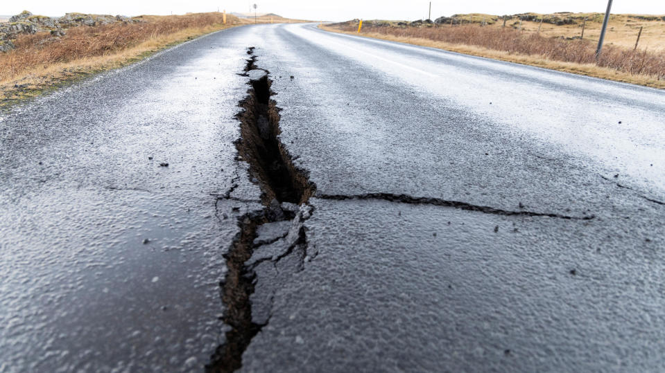 Cracks emerge on a road due to volcanic activity at the entrance to Grindavik, Iceland November 11, 2023.  / Credit: RUV/Ragnar Visage/Handout via REUTERS