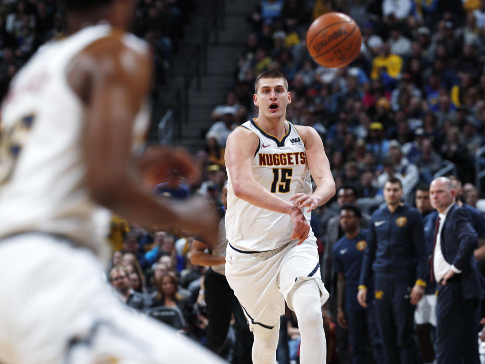 FILE - In this Tuesday, Jan. 1, 2019, file photo, Denver Nuggets center Nikola Jokic, right, sends a pass down the court to guard Malik Beasley during the second half of an NBA basketball game against the New York Knicks in Denver. Jokic, a 7-footer from Serbia, is leading the Nuggets to new heights so far this season with his style of play in the pivot. (AP Photo/David Zalubowski, File)
