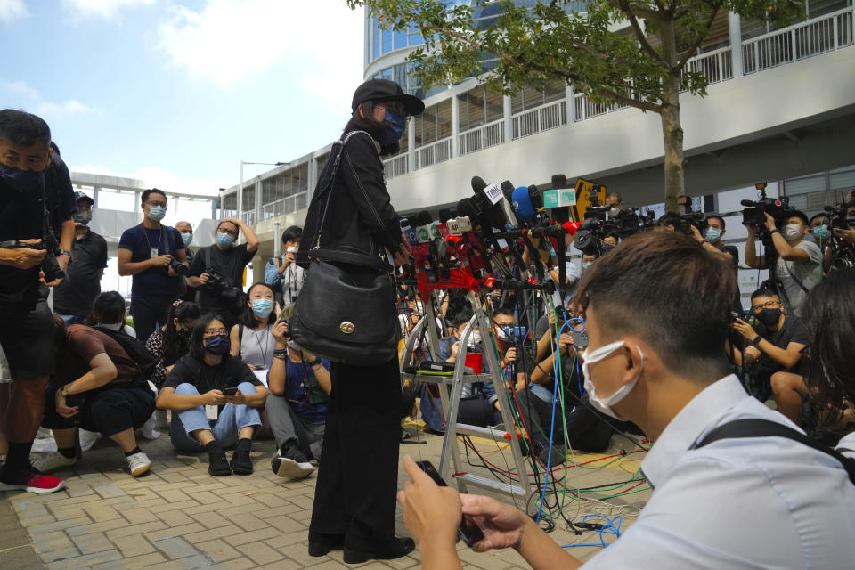 Mrs. Poon, the mother of a young woman killed in Taiwan, speaks to the media outside the government headquarters in Hong Kong, Wednesday, Oct. 20, 2021. Mrs. Poon, whose daughter Poon Hiu-wing was killed while visiting Taiwan in 2018, has lambasted Hong Kong authorities for letting suspect Chan Tong-kai walk free, instead of sending him to Taiwan to turn himself in. (AP Photo/Kin Cheung)