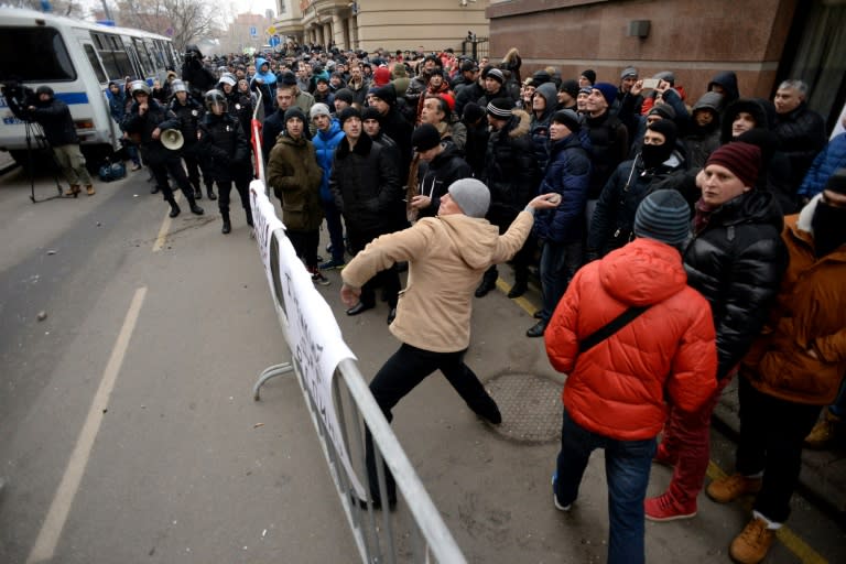 A protester throws a stone towards the Turkish embassy in Moscow on November 25, 2015