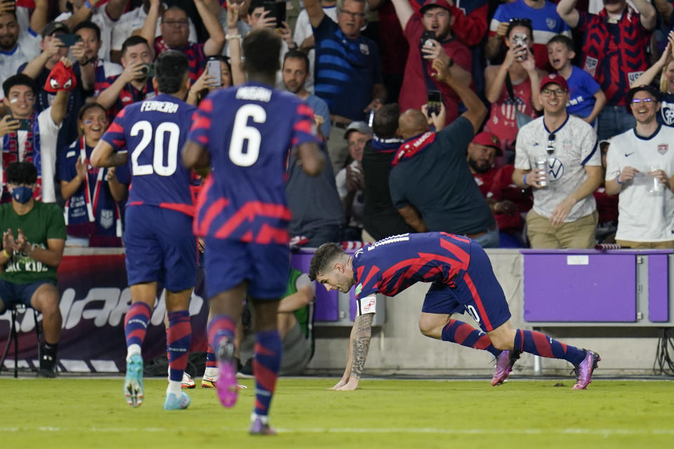 United States' Christian Pulisic, right, celebrates after scoring a goal on a penalty kick, his second of the game, during the first half of a FIFA World Cup qualifying soccer match against Panama, Sunday, March 27, 2022, in Orlando, Fla. (AP Photo/Julio Cortez)