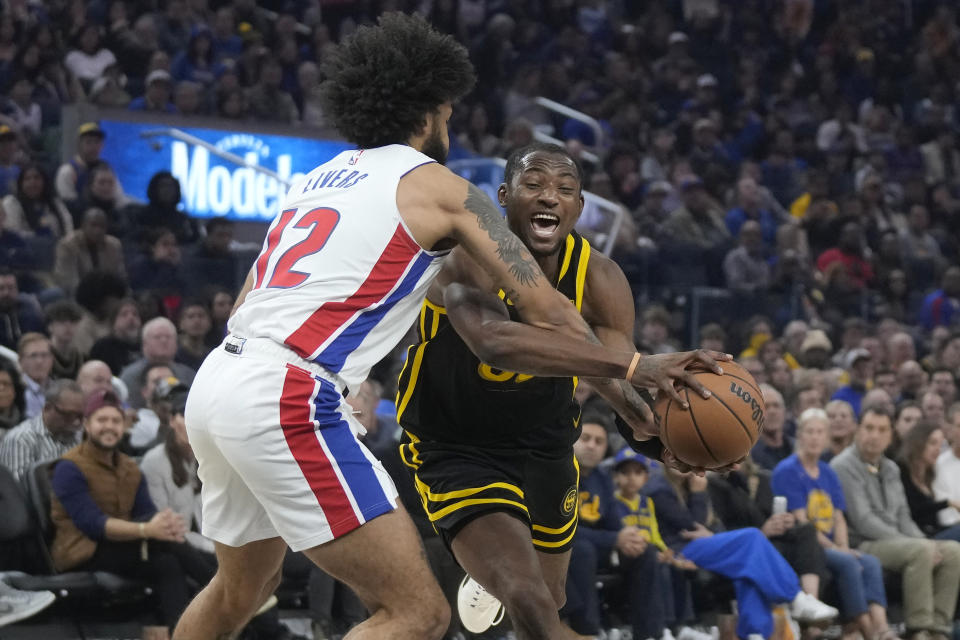 Golden State Warriors forward Jonathan Kuminga, right, drives to the basket against Detroit Pistons forward Isaiah Livers during the first half of an NBA basketball game in San Francisco, Friday, Jan. 5, 2024. (AP Photo/Jeff Chiu)