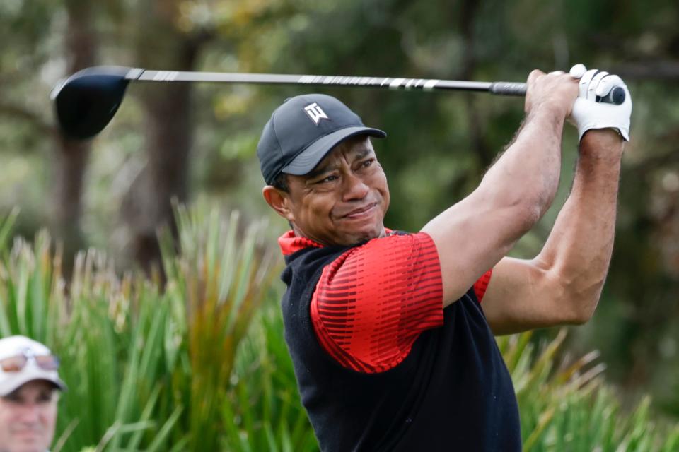 FILE - Tiger Woods tees off of the 3rd hole during the final round of the PNC Championship golf tournament on Dec. 18, 2022, in Orlando, Fla. Woods is returning to competition for the first time without the use of a cart since July, announcing Friday, Feb. 10, 2023, that he will play next week at Riviera in the Genesis Invitational. (AP Photo/Kevin Kolczynski, File)