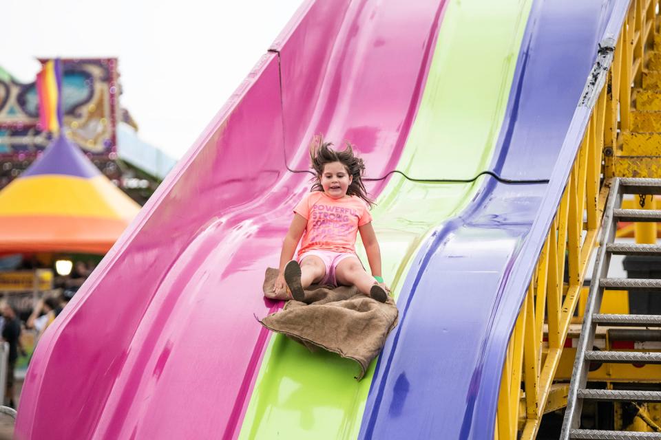 Trinity Archuleta, 6, catches some air as she comes down the ‘Super Slide’ at the Colorado State Fair on Wednesday September 1, 2021.