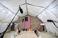 U.S. President Donald Trump, flanked by National Security Adviser John Bolton, first lady Melania Trump and U.S. Ambassador to Iraq Doug Silliman, meets political and military leaders during an unannounced visit to Al Asad Air Base, Iraq December 26, 2018. REUTERS/Jonathan Ernst