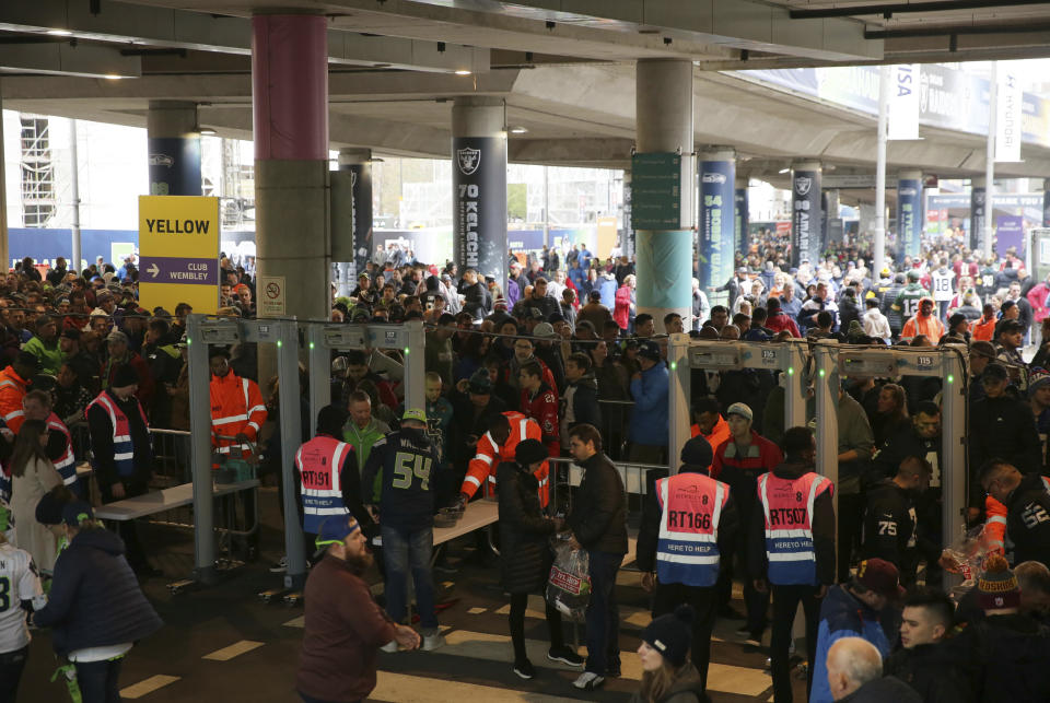 People are held-up by increased security checks as they arrive for an NFL football game between Seattle Seahawks and Oakland Raiders at Wembley stadium in London, Sunday, Oct. 14, 2018. (AP Photo/Tim Ireland)