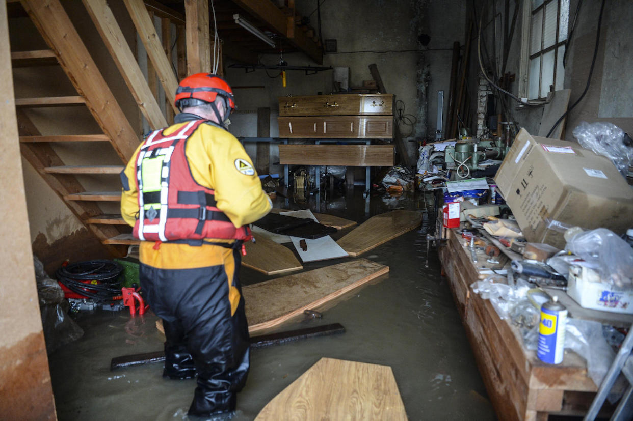 Coffins floating inside a flooded funeral home in Fishlake, South Yorkshire (Picture: SWNS)